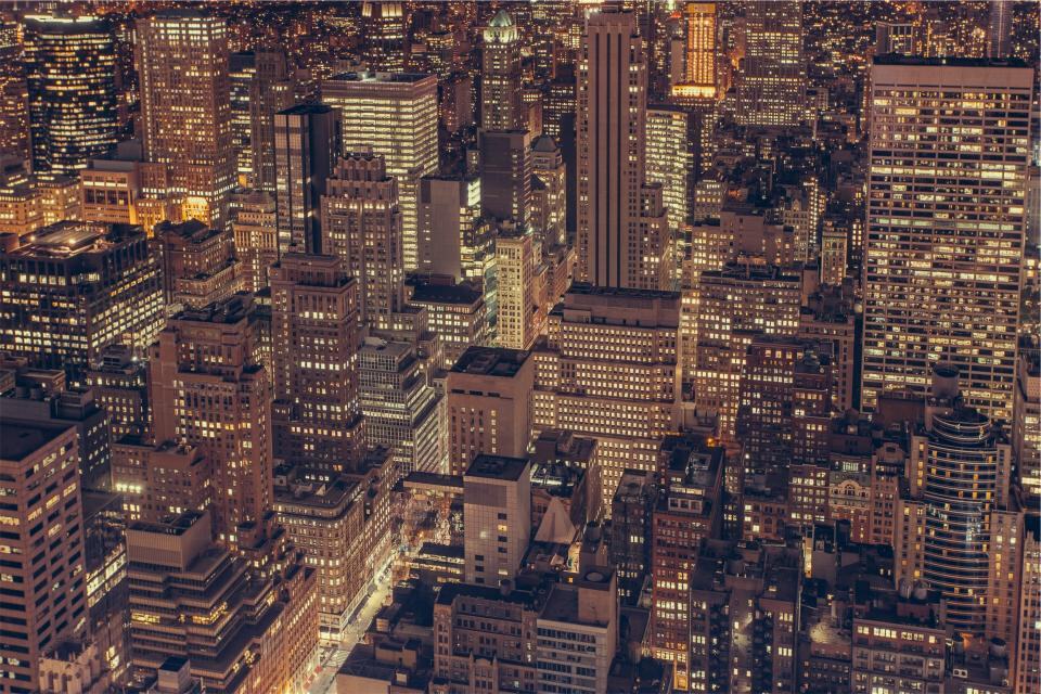 City buildings lit at night from above