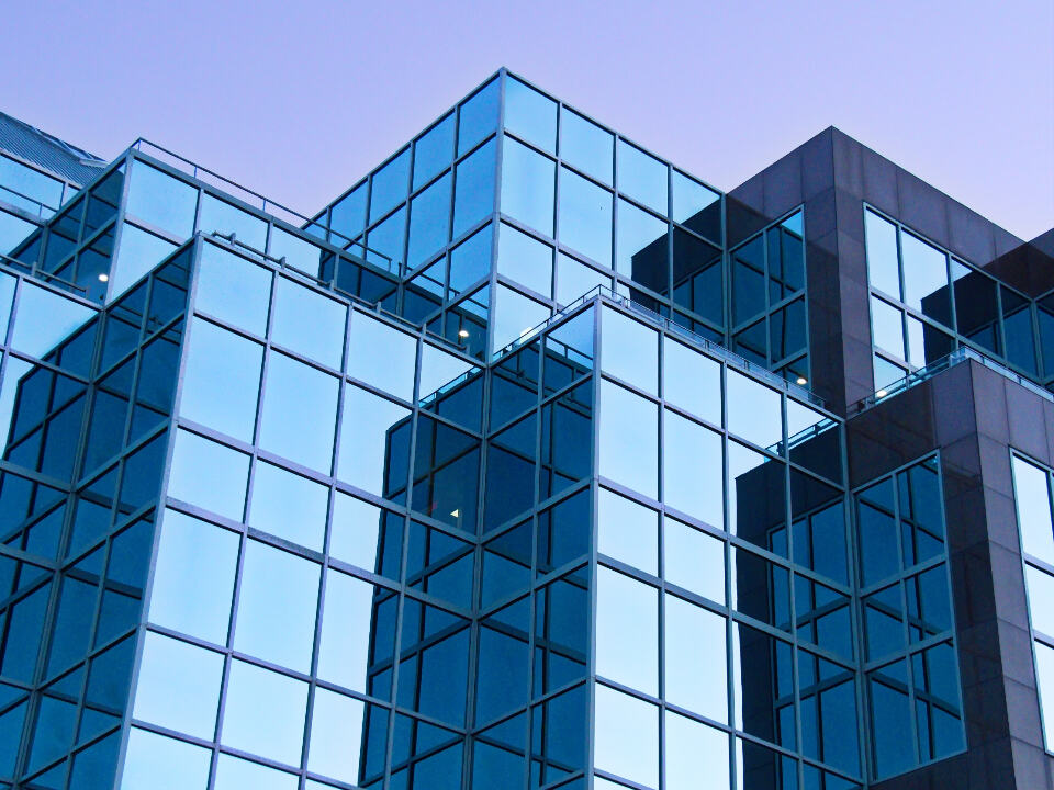 Glass office building facades at dusk